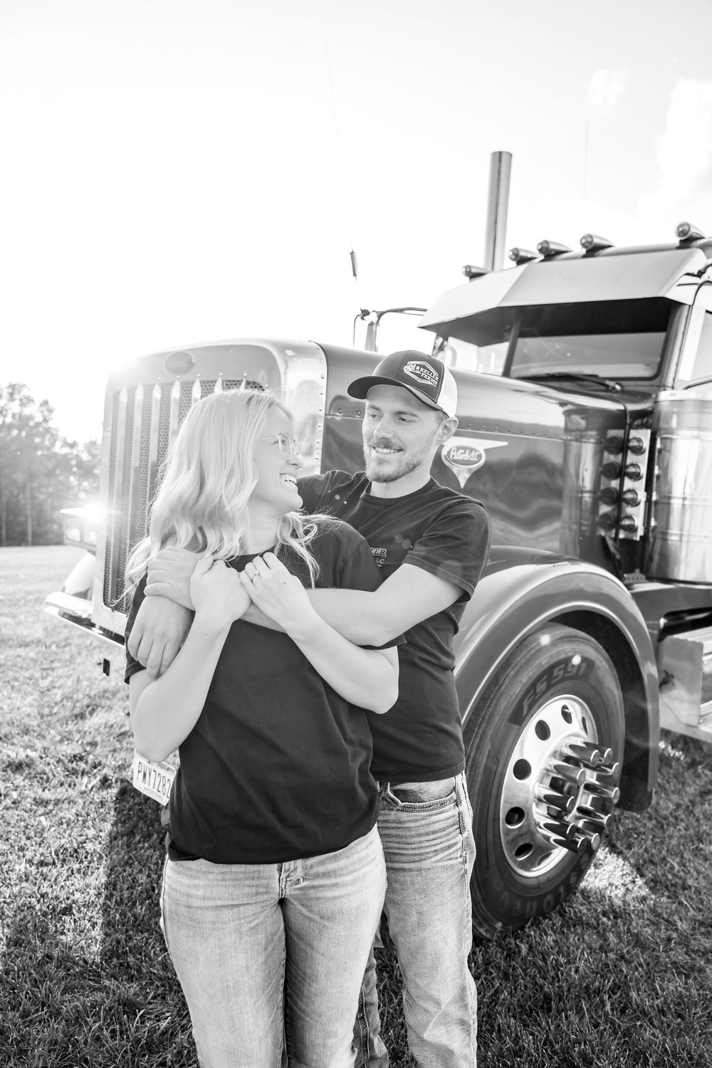 A series of black and white photos showing a couple embracing near a vintage truck in a grassy field.