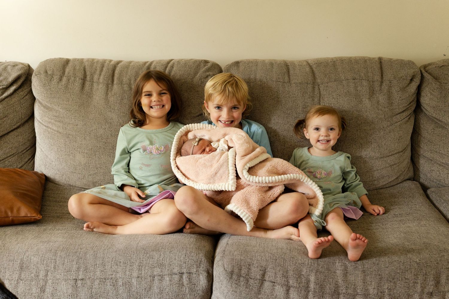 A series of six photos showing children sitting together on a gray couch in different poses.