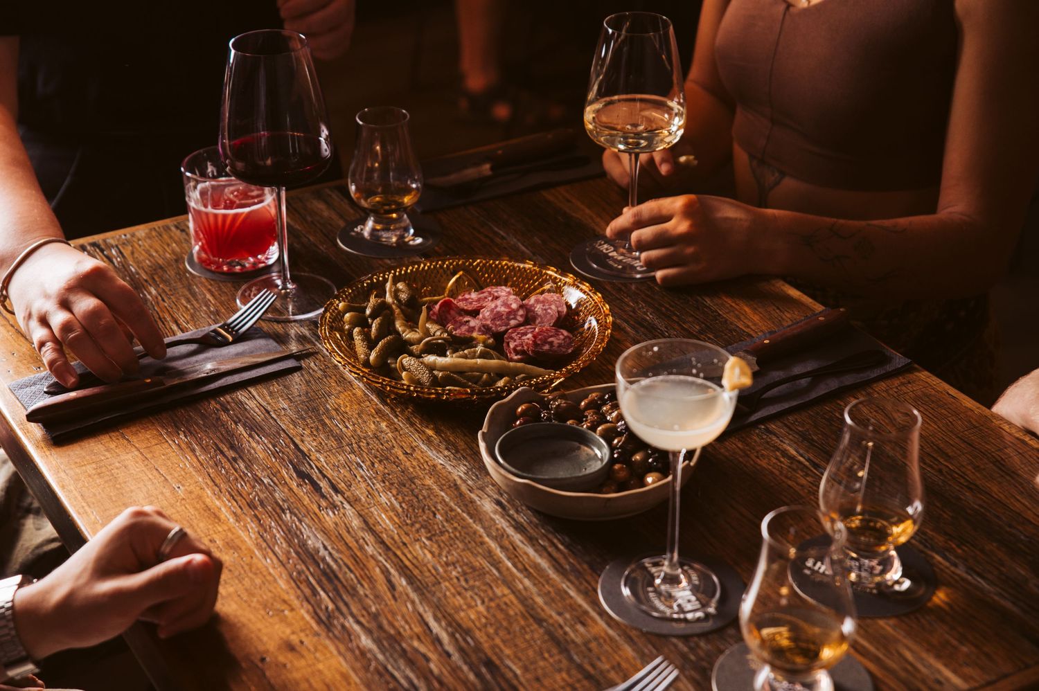 Wine tasting experience with charcuterie board and glasses on rustic wooden table