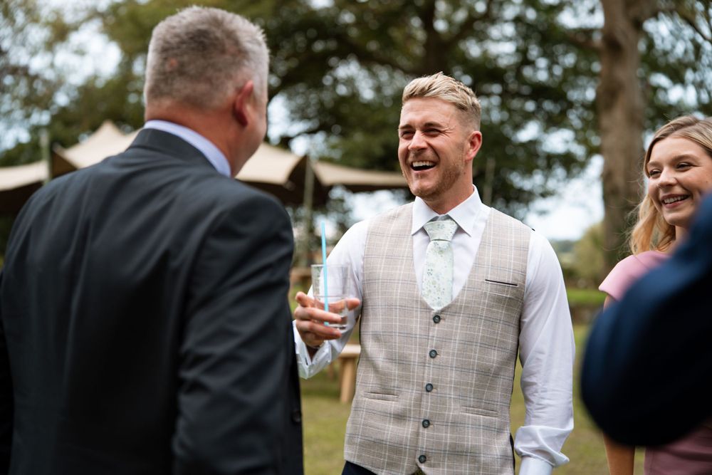Wedding guests enjoying outdoor celebrations on a sunny day.