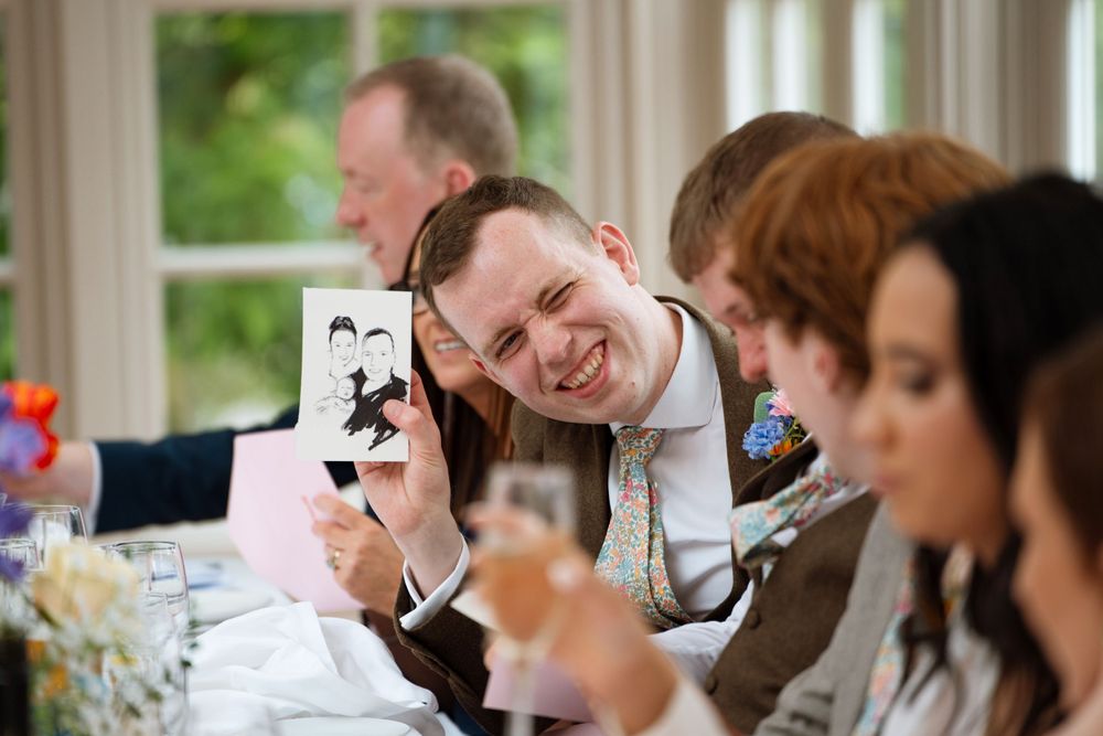 Guests sharing joyful moments at an elegant indoor wedding reception.