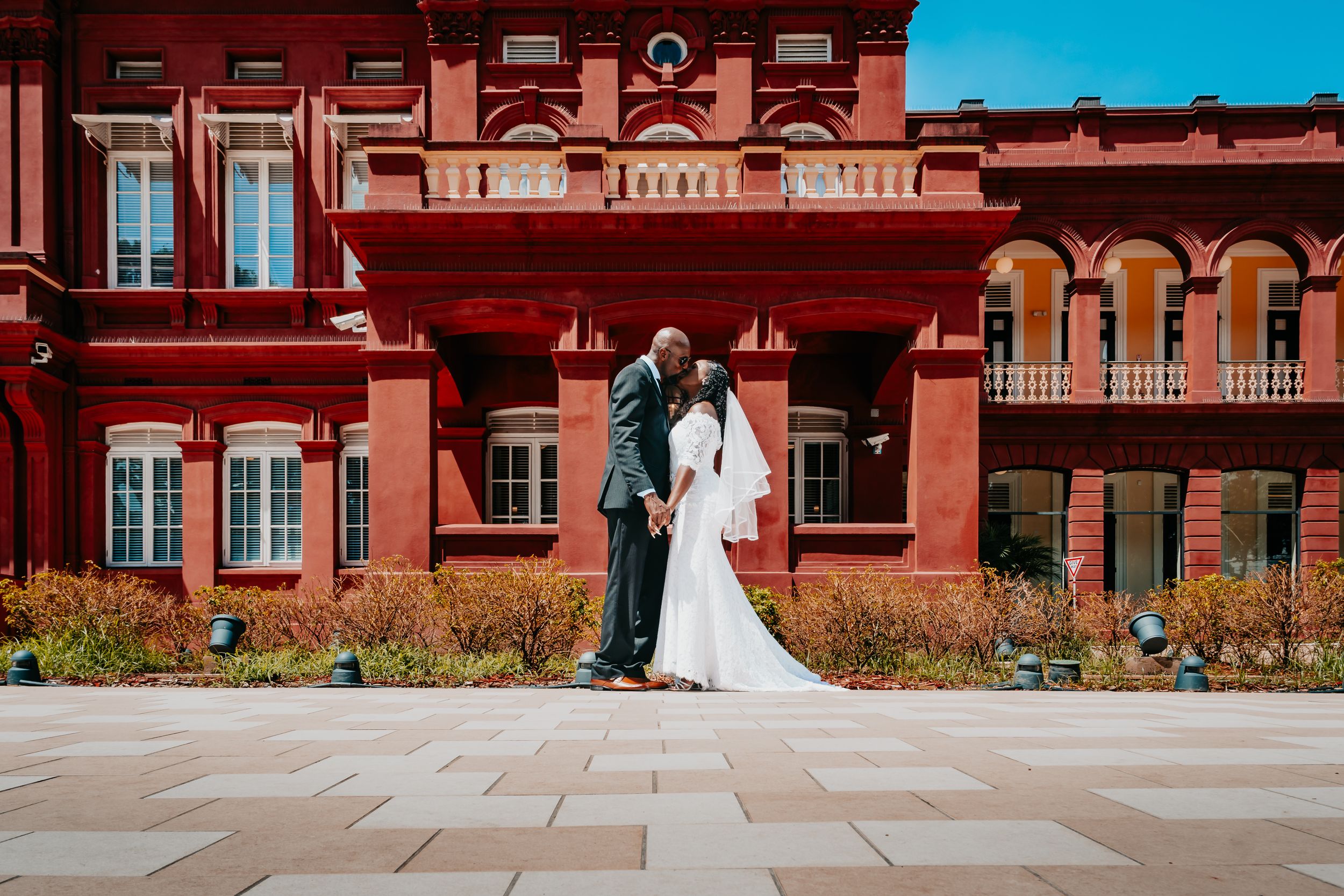 Wedding couple poses in front of the Red House in Port of Spain, Trinidad