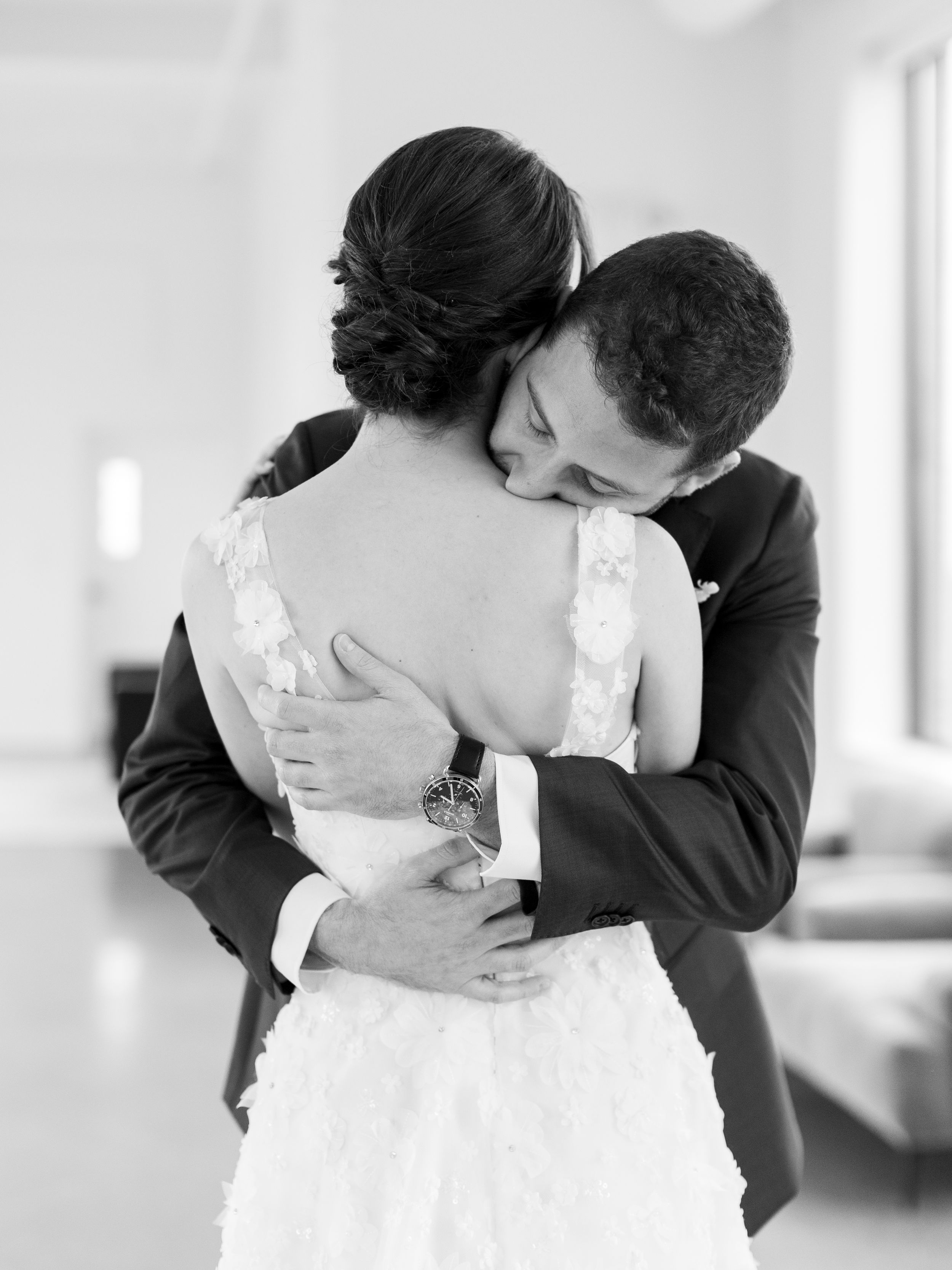Romantic black and white moments captured during a couple's first look at their wedding.