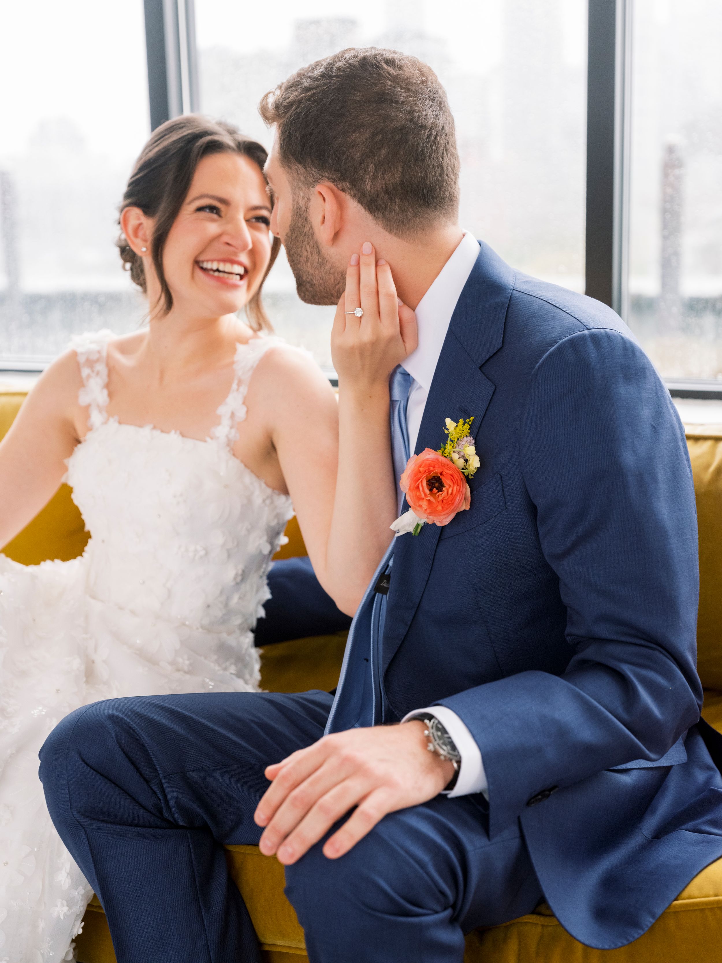 Candid wedding portraits showing tender moments between newlyweds against city window views.