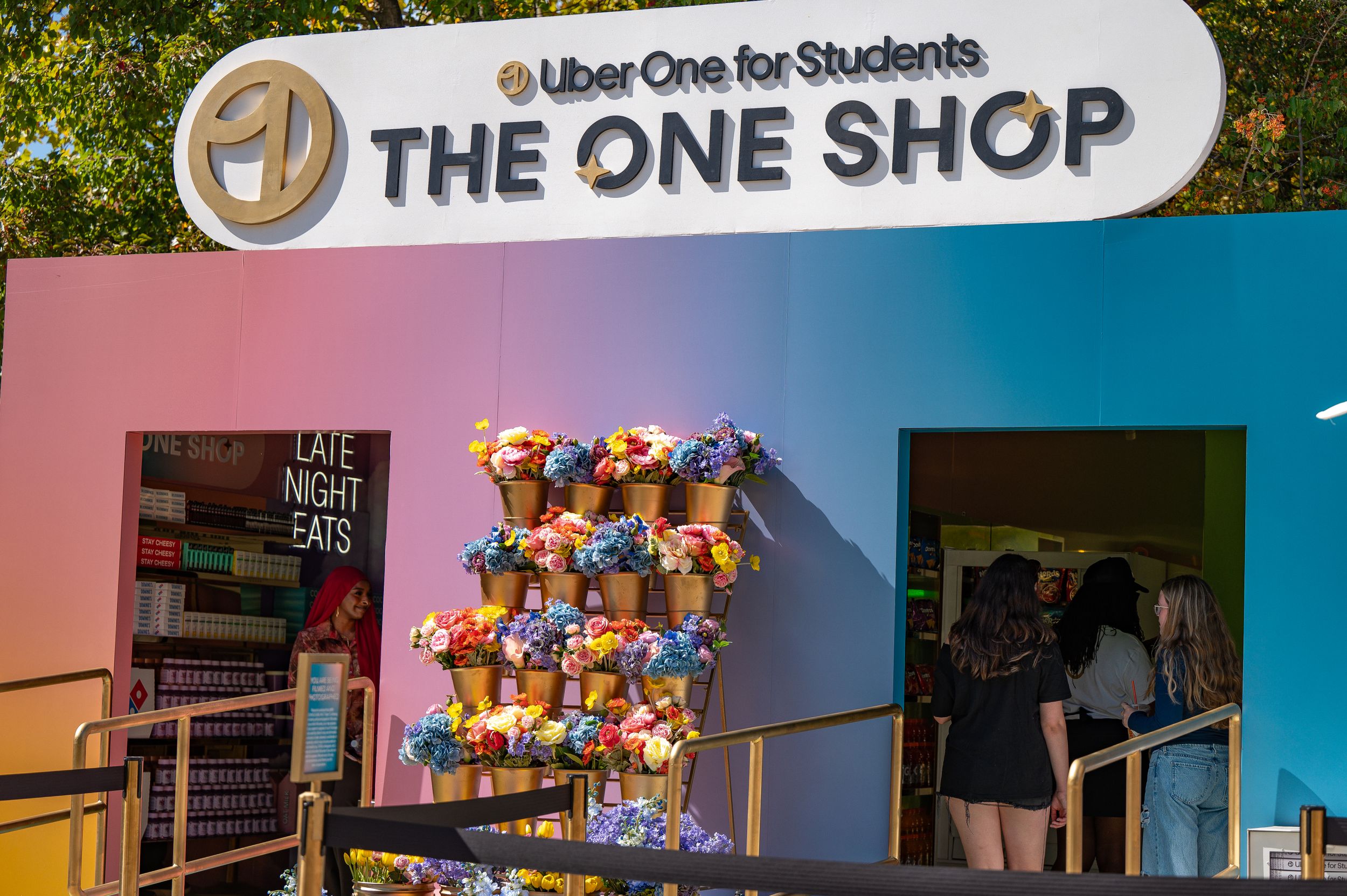 The One Shop storefront with colorful signage and merchandise displays.