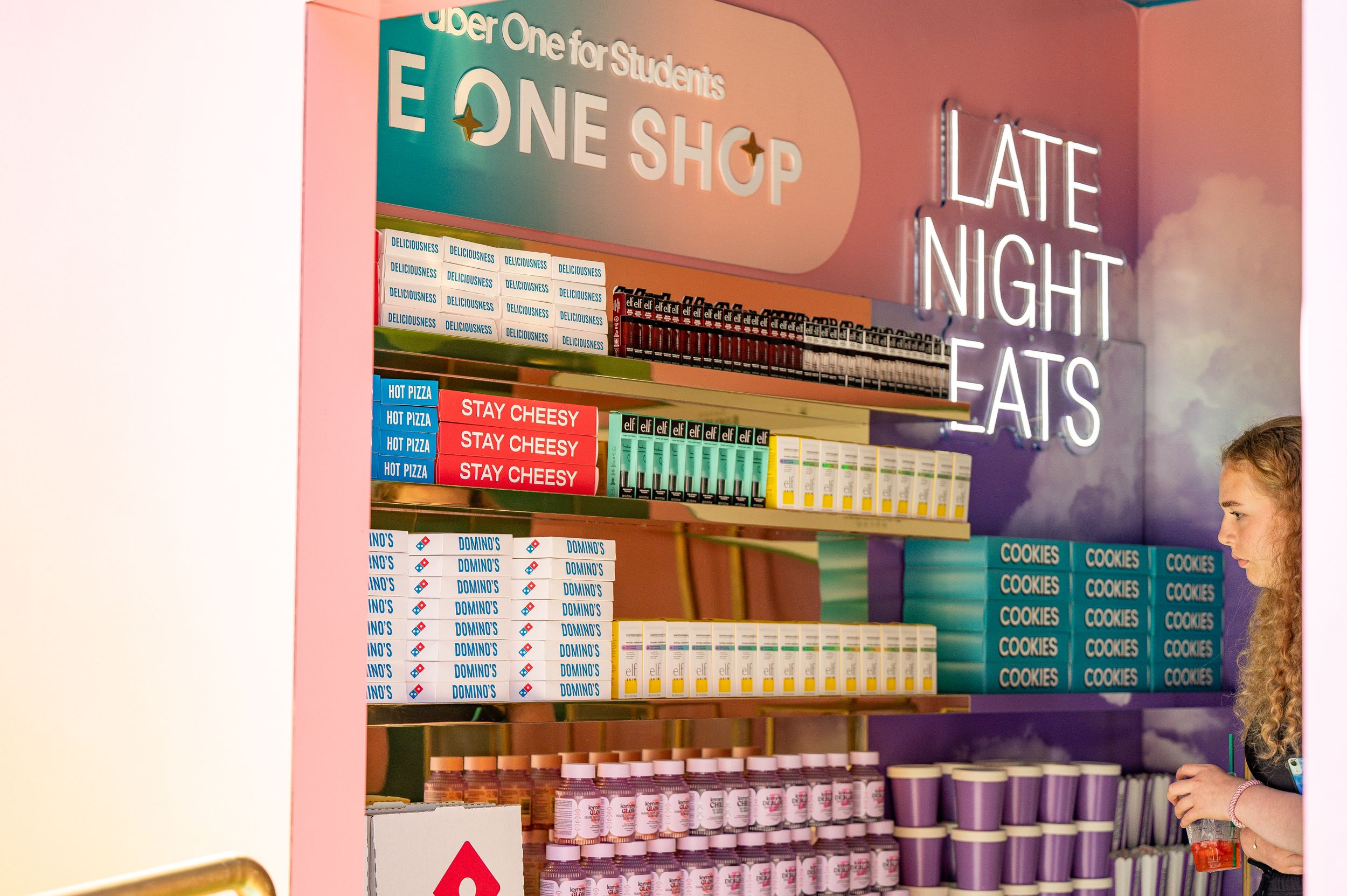 Interior view of The One Shop showing snack shelves and late night eats menu.