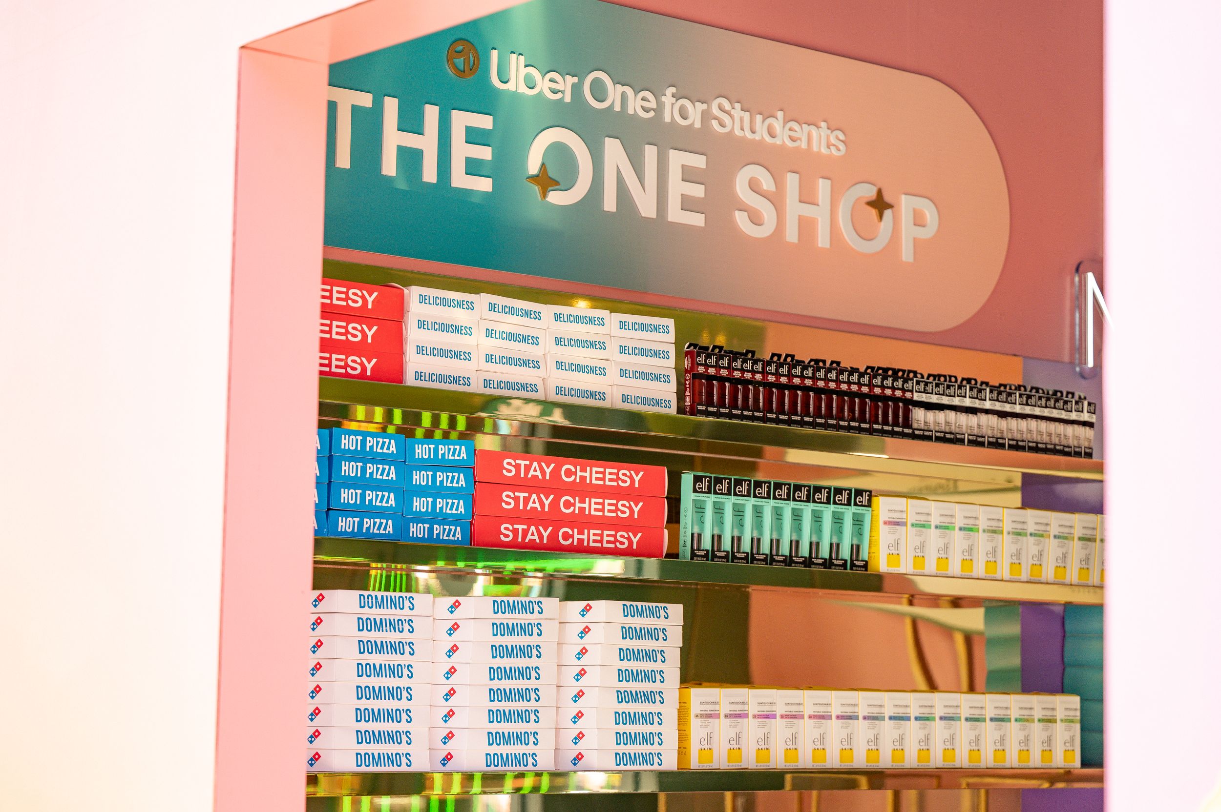 Menu board displaying prices and items at The One Shop convenience store.