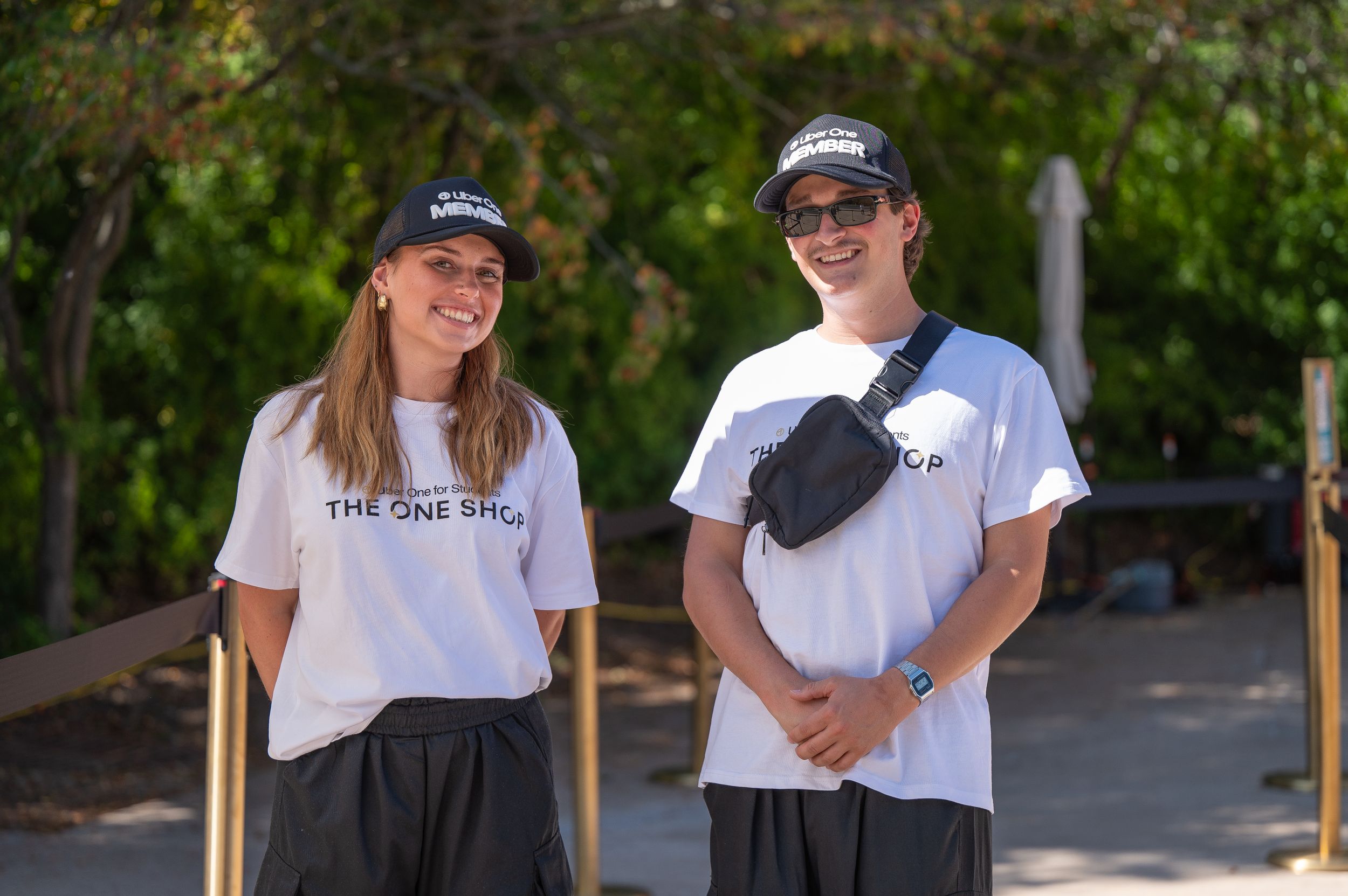 Staff members in white branded t-shirts outside The One Shop.