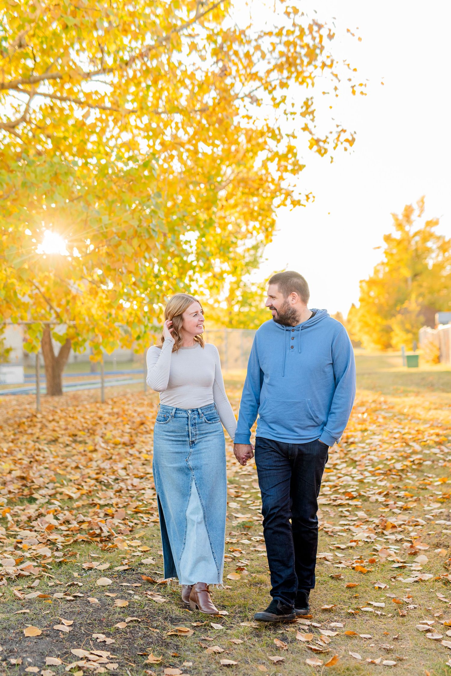 A tender romantic moment between a couple touching foreheads and smiling intimately at each other.