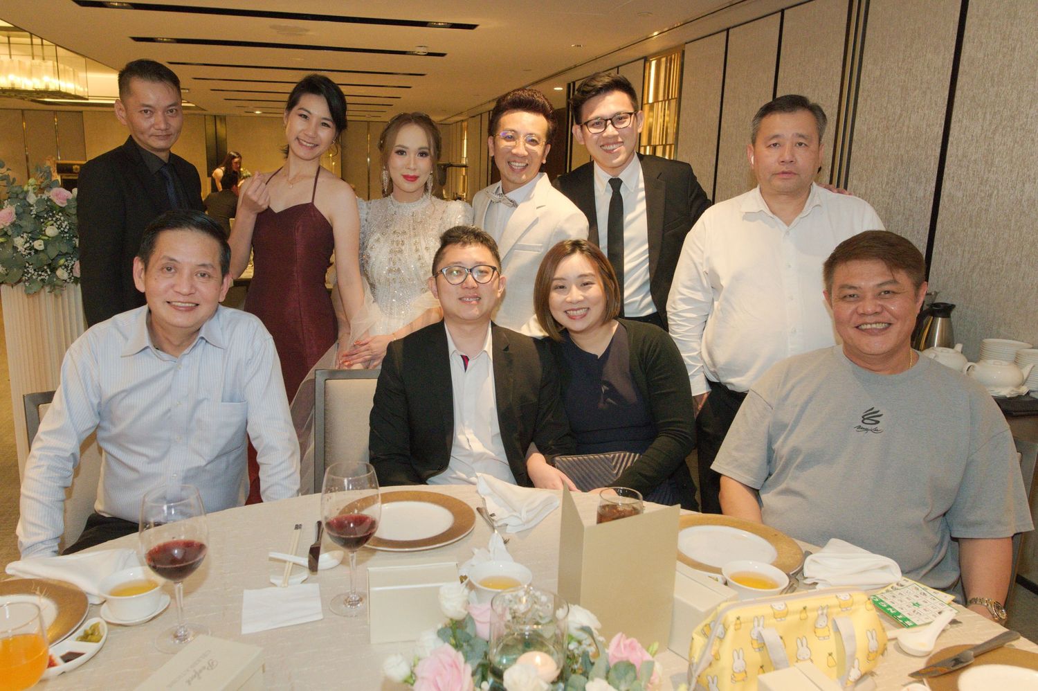 Wedding guests seated at a round table enjoying the reception dinner.