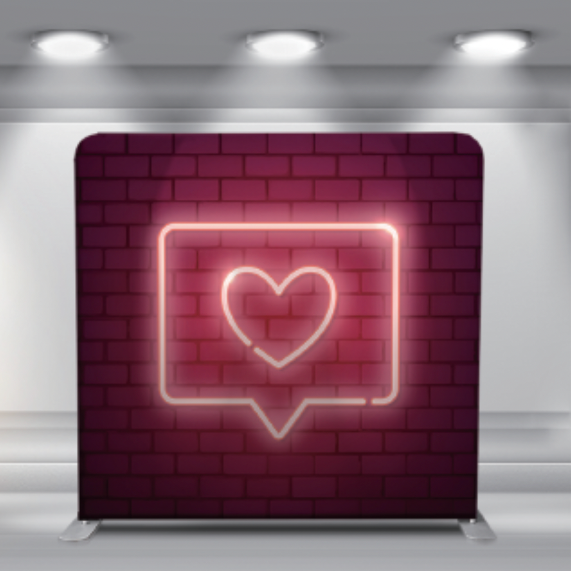 Neon heart icon in a speech bubble glowing pink against a brick wall backdrop under spotlights.