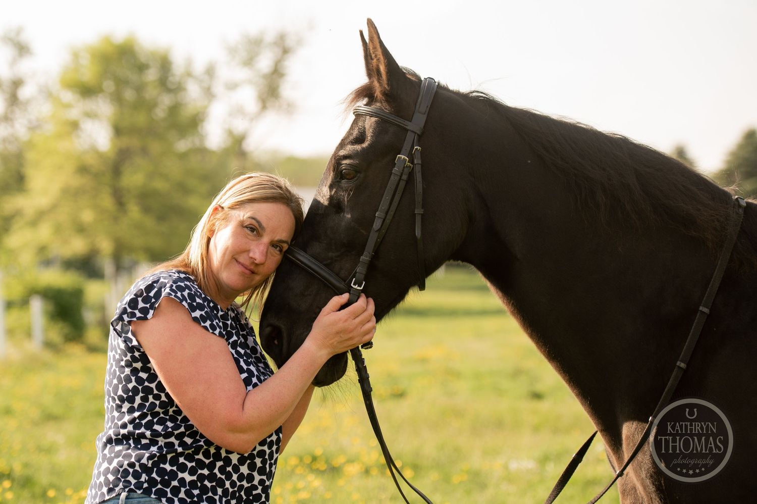 A sweet moment captured between a horse and someone wearing an animal print top in golden light.