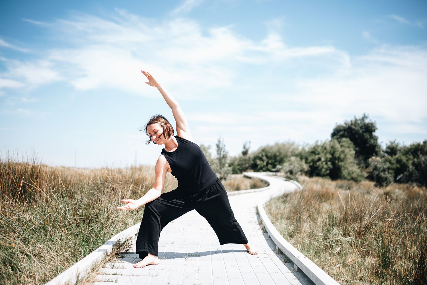 Yoga and qigong instructor doing stretches in an outdoor professional branding photo session with a Melbourne branding Photographer