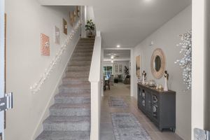 Carpeted staircase and hallway in modern home interior.
