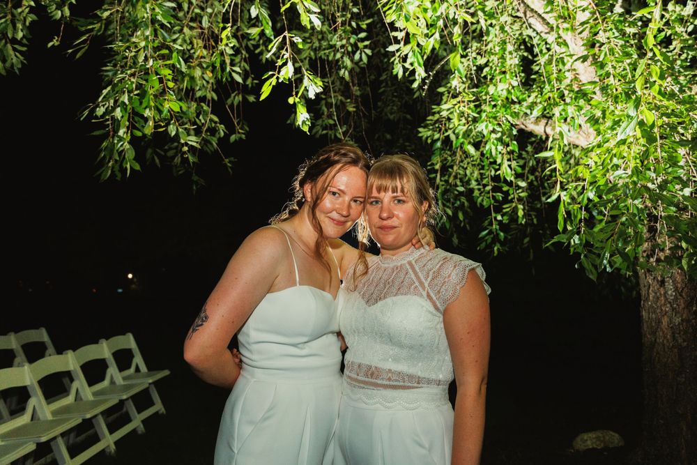 Evening garden wedding portrait under natural greenery.