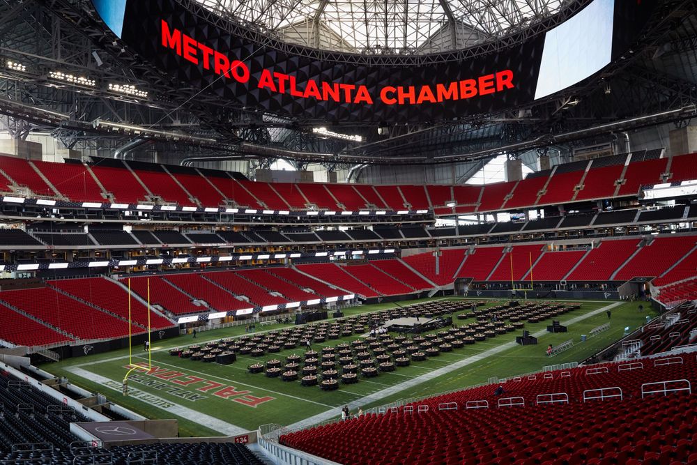 Interior view of Mercedes-Benz Stadium with red seats and football field in Atlanta.