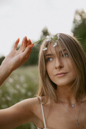 A series of cropped portraits showing a person with blonde hair wearing a white tank top while posing outdoors.