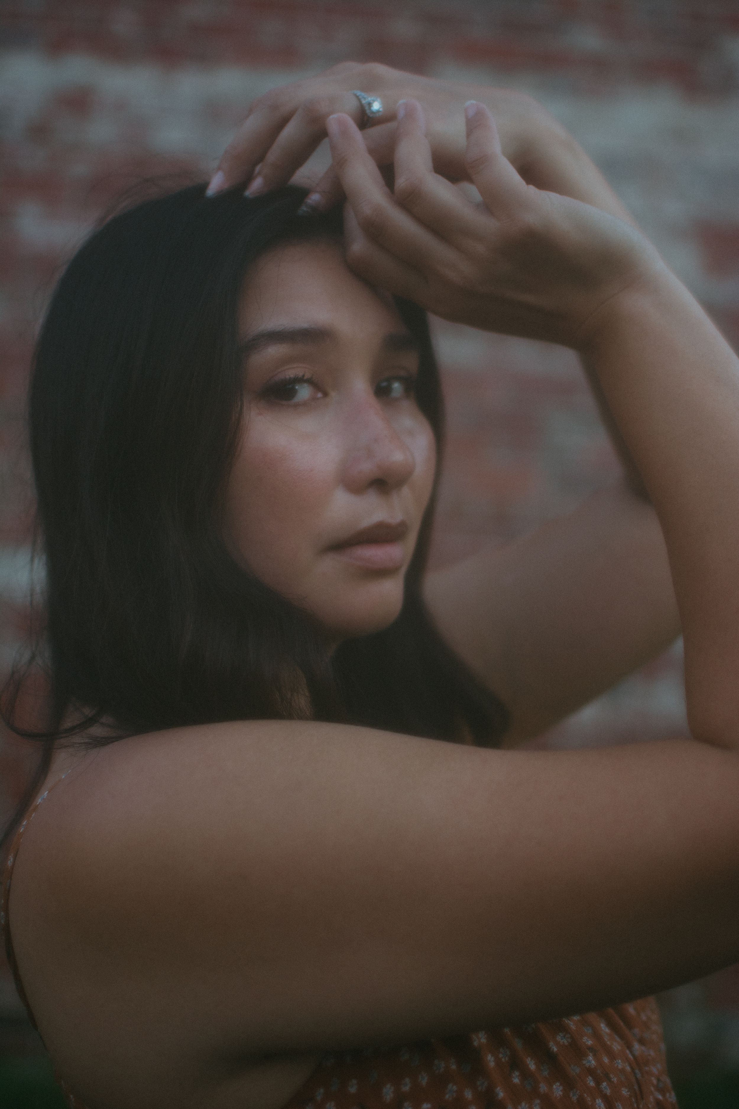 portrait of a woman with her hands on her face
