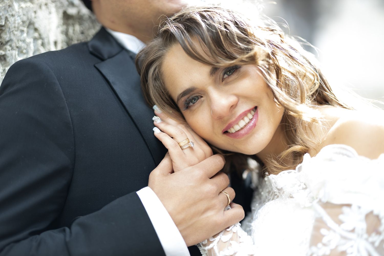 Intimate wedding moment captured against formal attire.