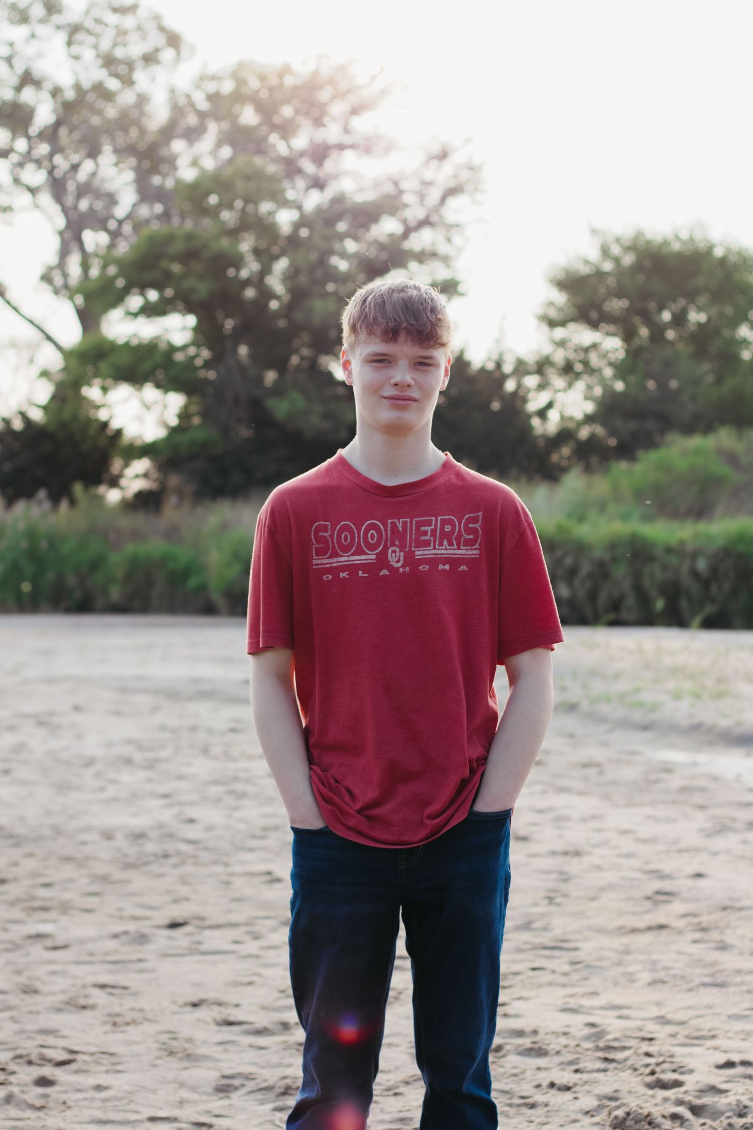 High school senior stand in river for senior photo session in Central Nebraska.