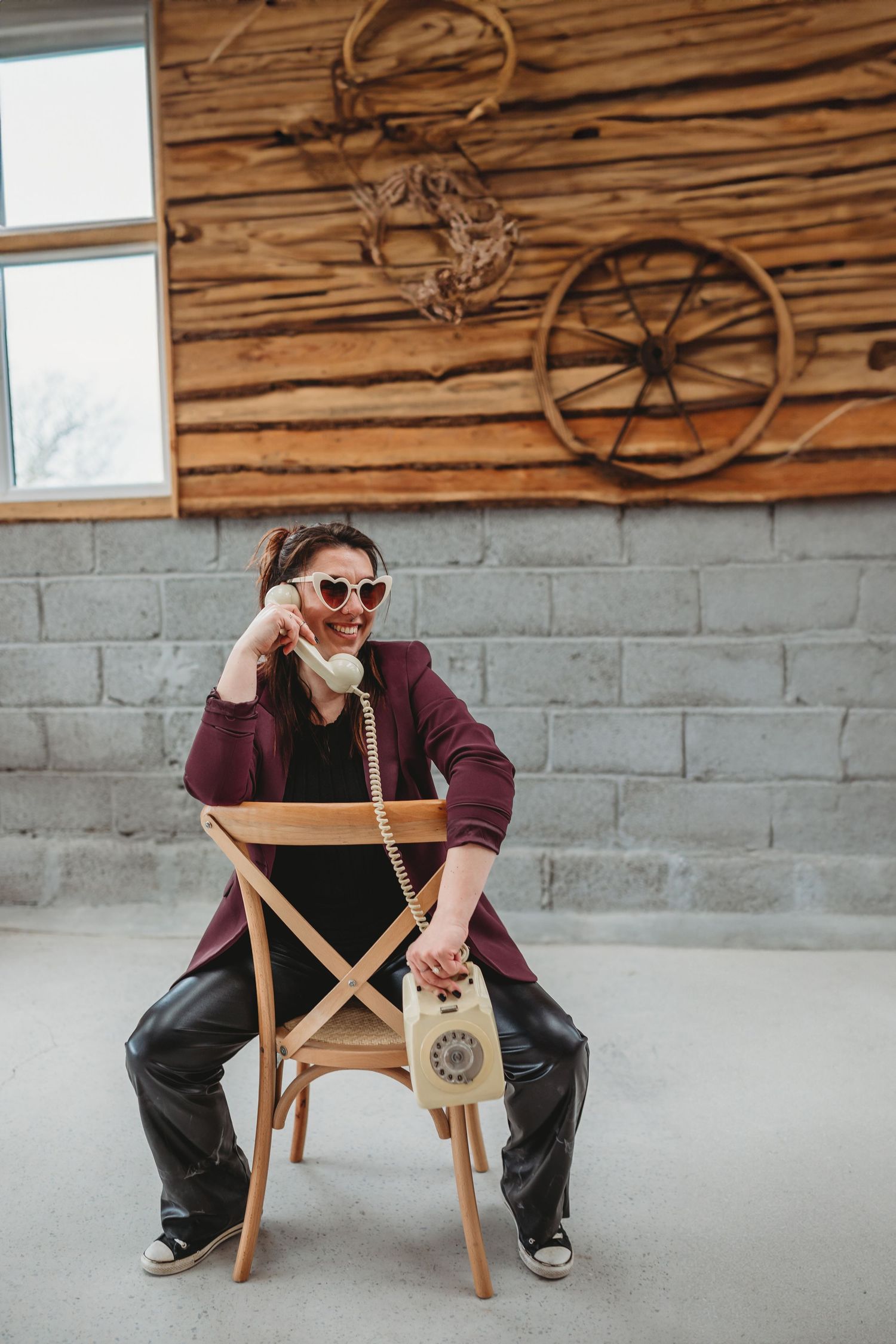 Wedding photographer and brides wearing sunglasses takes cheerful selfie outdoors.