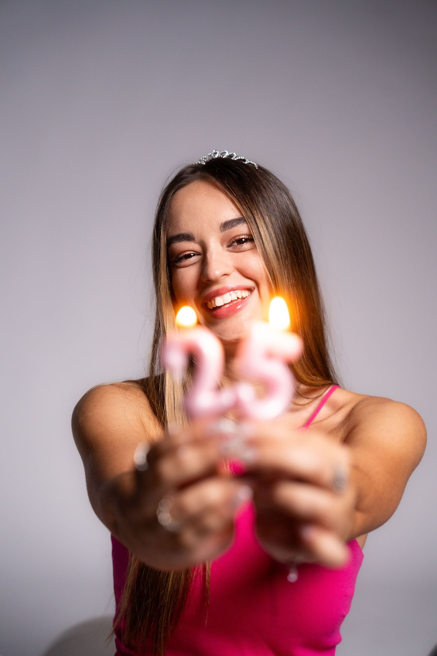 Joyful poses with hands extended toward camera against light studio background.