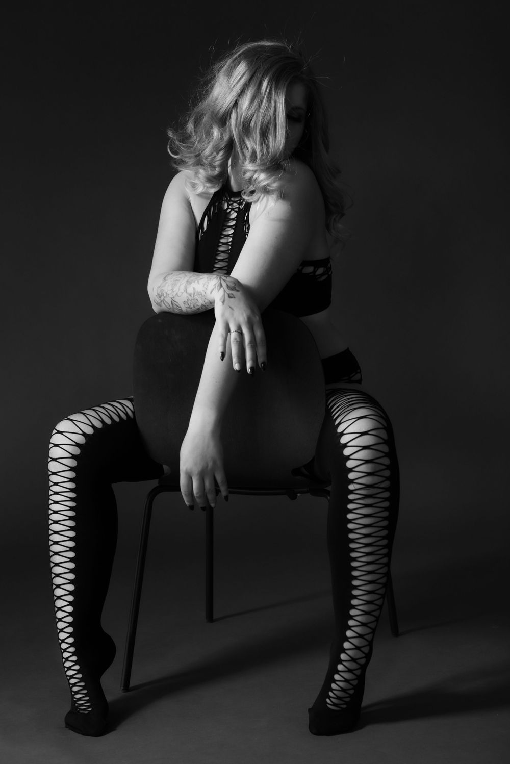 Dramatic studio portraits showcasing lace-up boots in dark lighting.