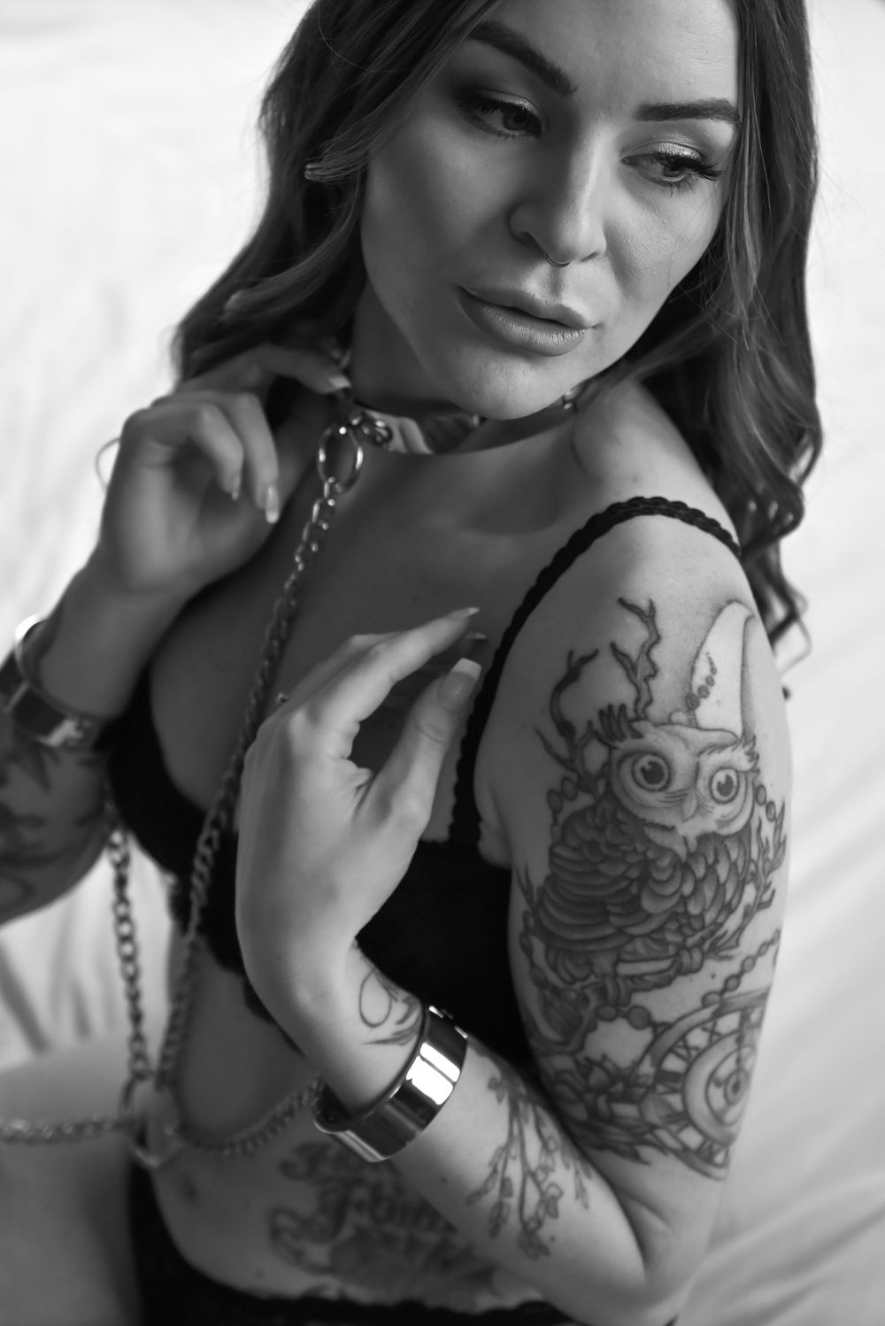 Close-up black and white portraits showcasing intricate arm tattoo artwork.