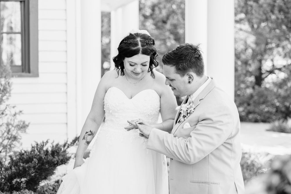 Black and white candid moment showing joyful laughter during wedding day.