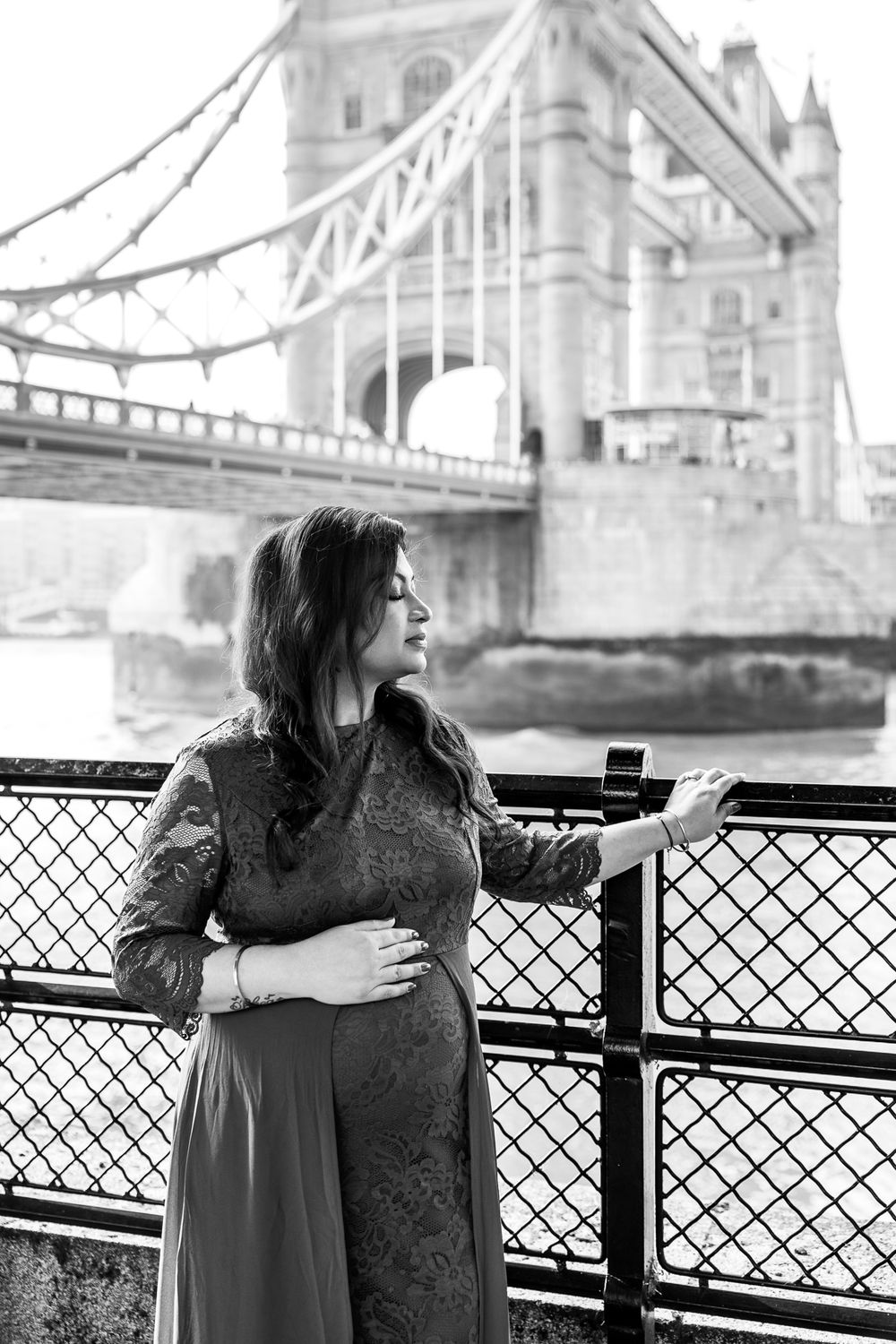 woman holding her pregnant belly looking into distance