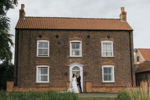 Panoramic sequence showing a historic red brick farmhouse with traditional Georgian architecture and white windows.