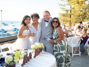 Group photos at an elegant outdoor lakeside wedding reception featuring decorative white chairs and floral arrangements.