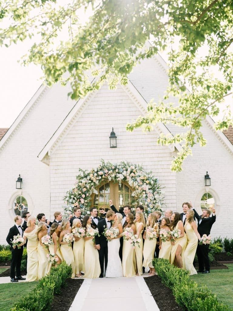 Wedding party in front of the chapel at The Nest at Ruth Farms, a Dallas wedding venue
