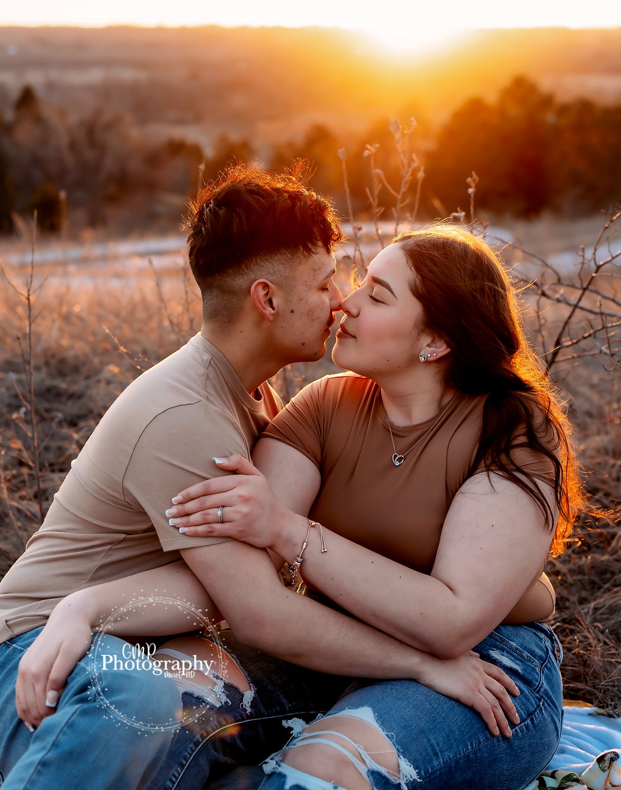 Newly Weds snuggling with the sunset behind them.