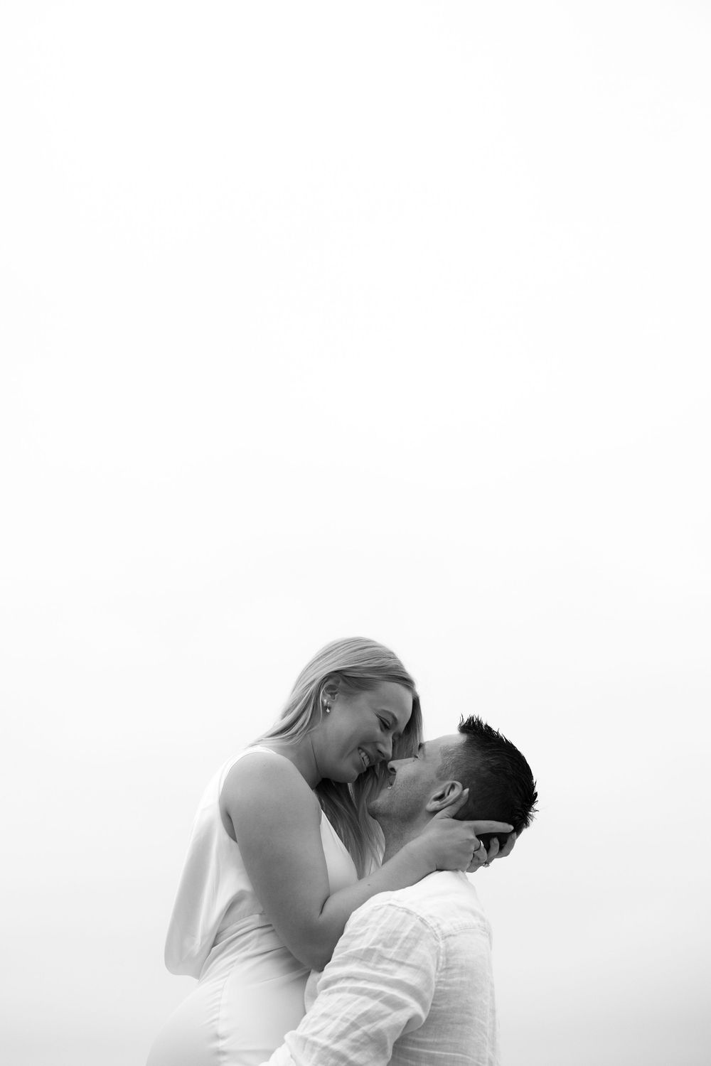 A black and white artistic photo series shows a couple in intimate dance poses against a minimalist background.
