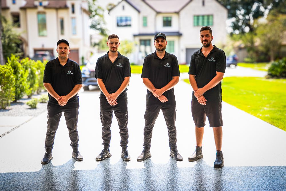 Professional service team members standing in uniform outdoors.
