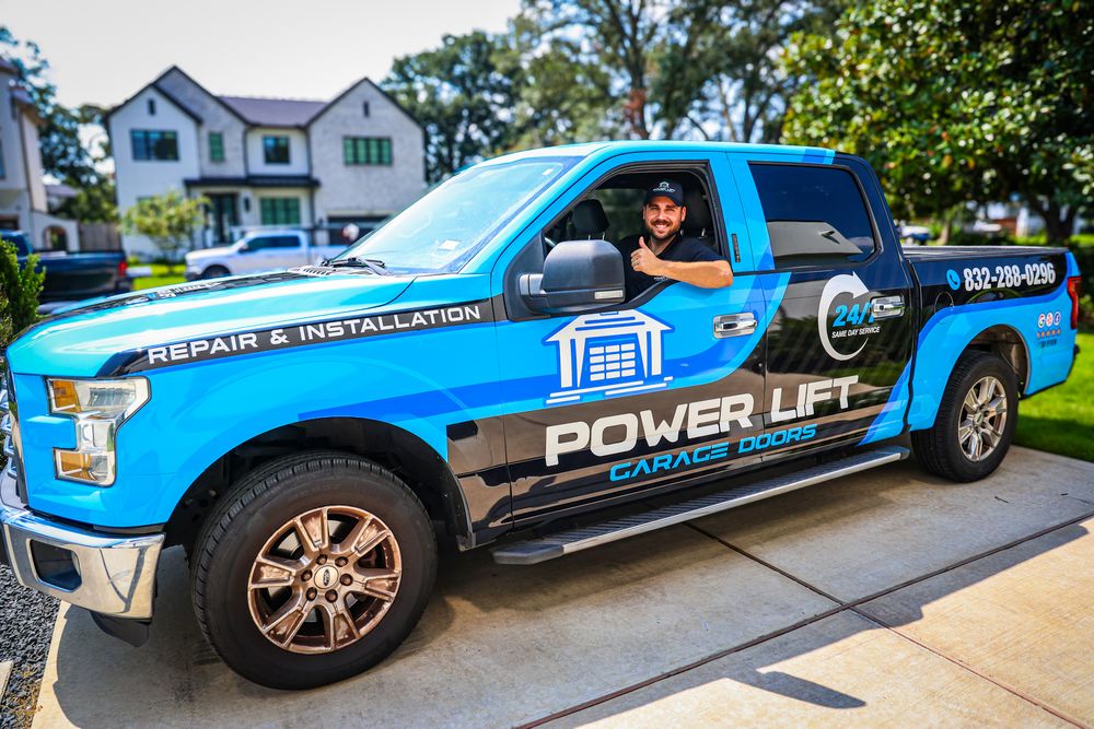 Blue branded service trucks parked in front of residential homes.
