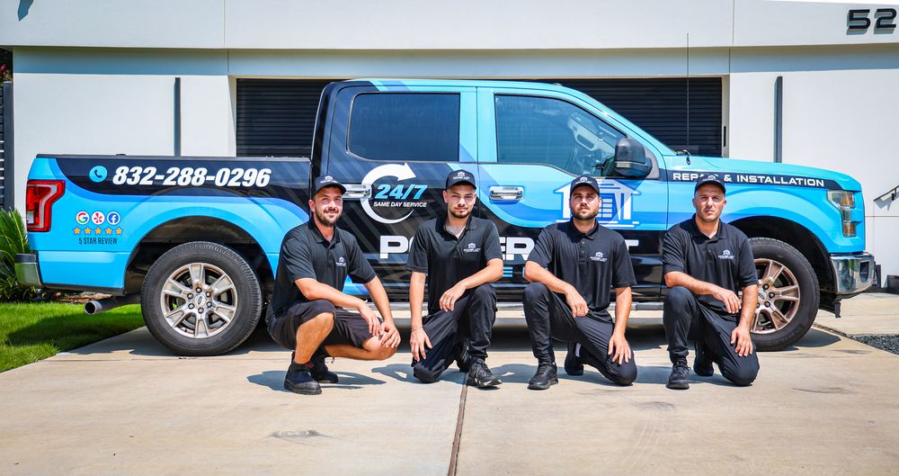 Professional service team sitting together outside company vehicles.