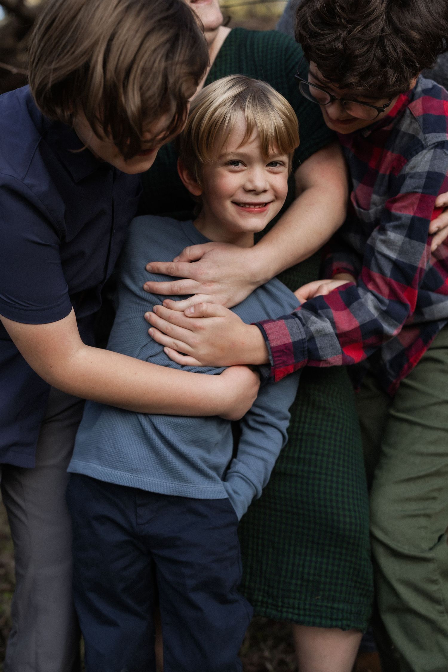 A heartwarming family moment shows playful affection and hugging.