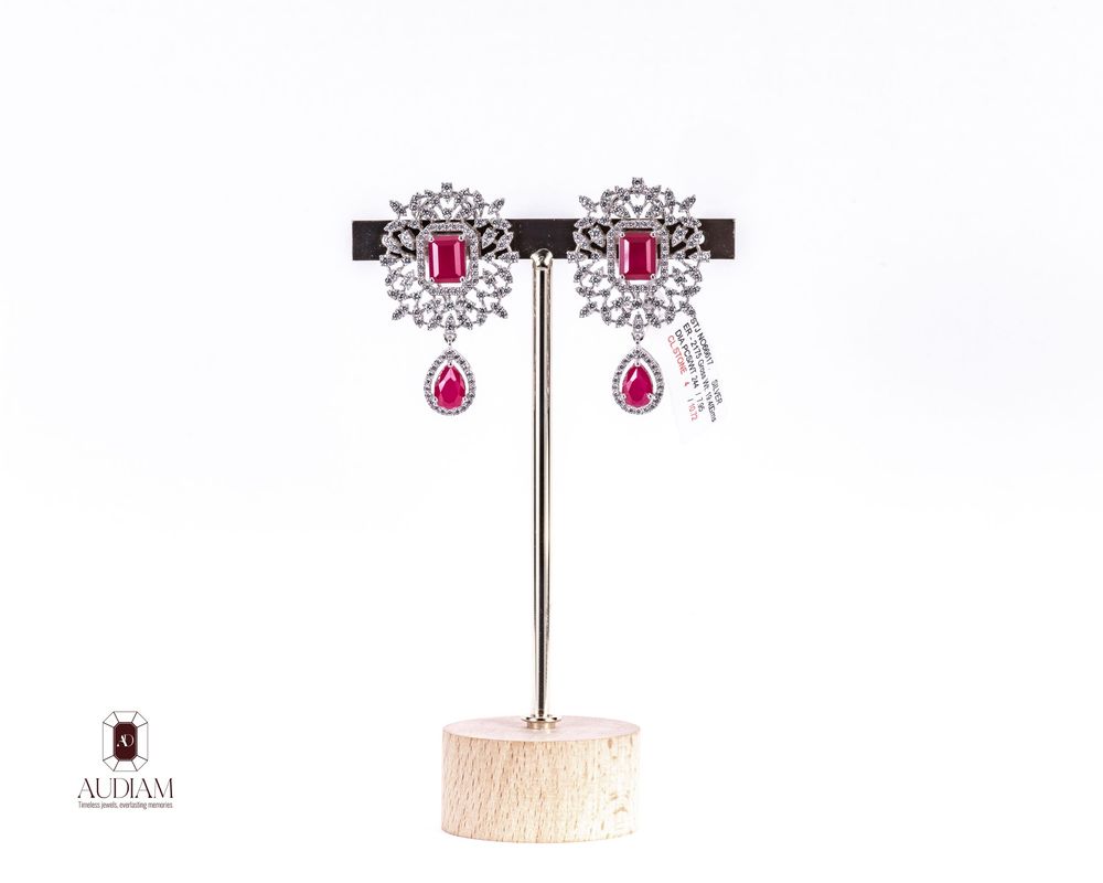 Detailed schematic drawing of luxury drop earrings with pink gemstones and diamond accents.