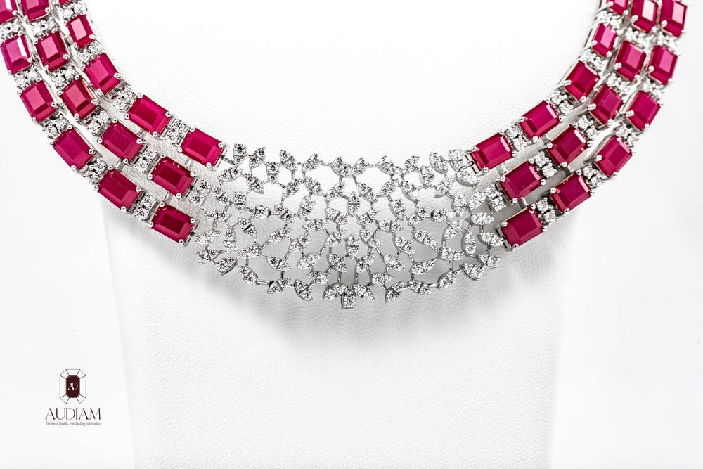 Elegant curved jewelry necklace design featuring alternating ruby red and clear diamond gemstones in white gold setting.