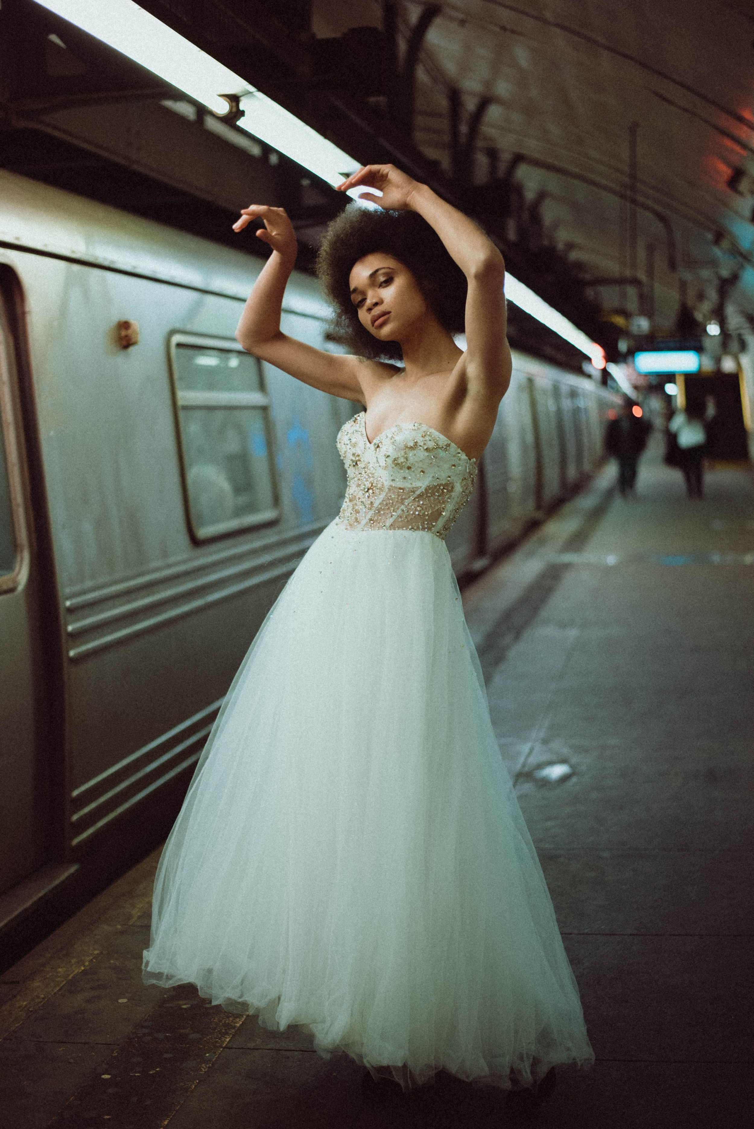 A portrait of a bride posing in from of the subway in New York City.