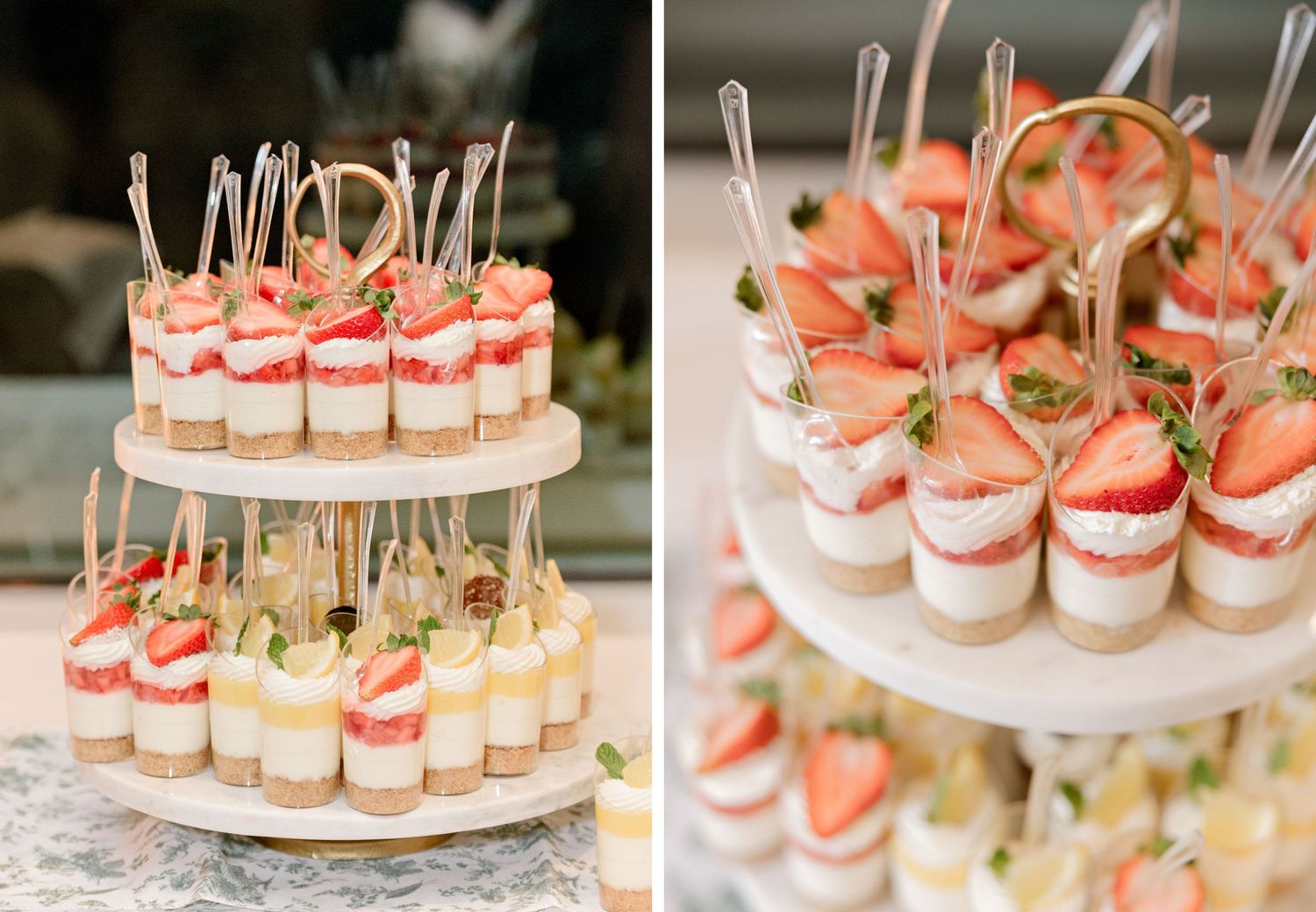 Two-tiered display of pink and white layered desserts topped with fresh strawberries on elegant cake stands.
