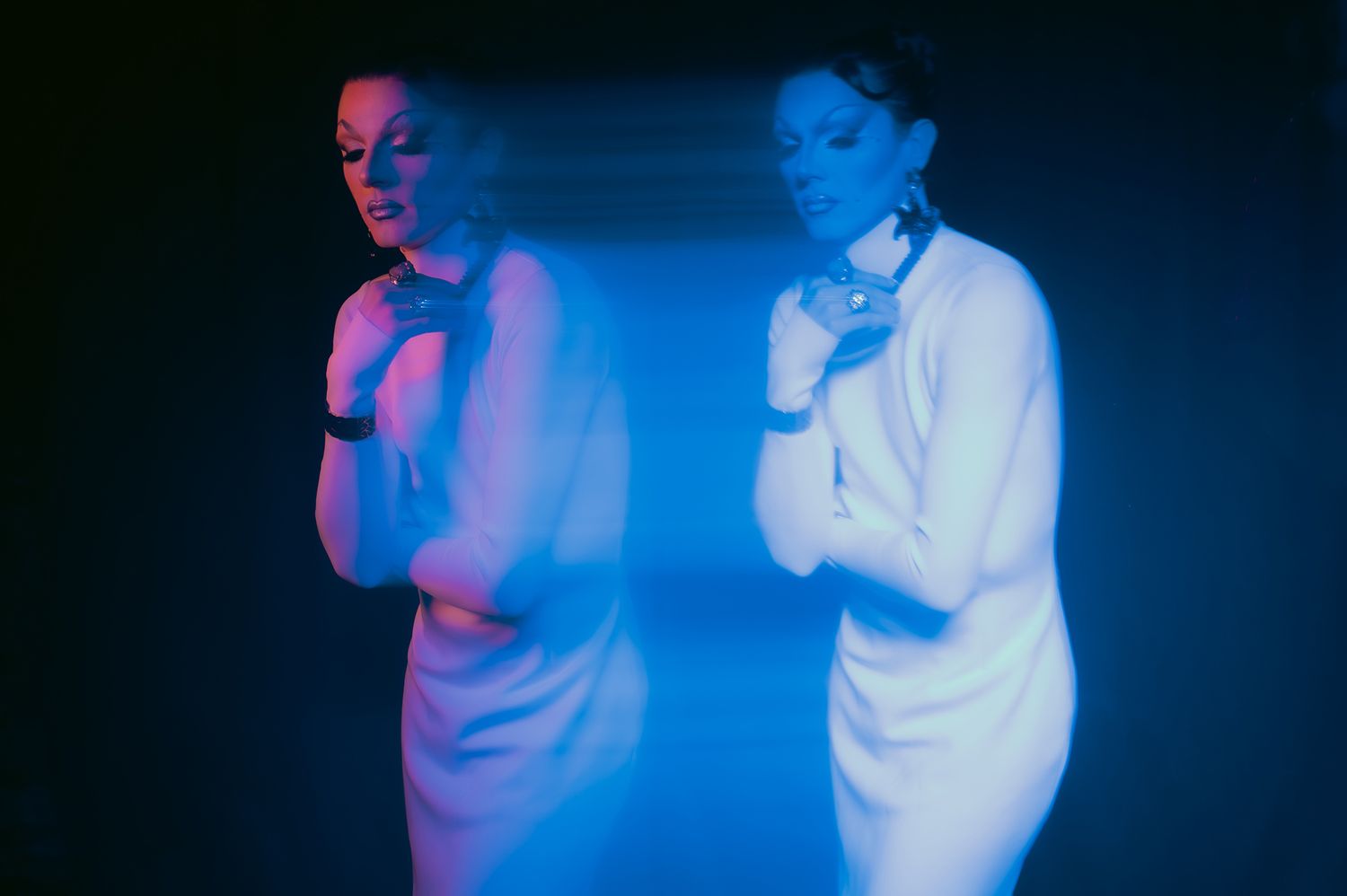 Dark nightclub scene with blue lighting creating atmospheric silhouettes.