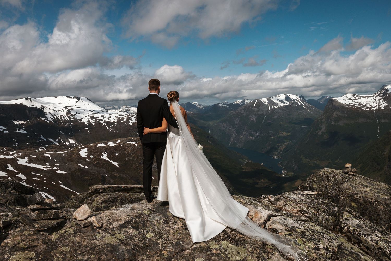 A couple shares a romantic kiss while kneeling at the altar during their intimate church wedding ceremony.