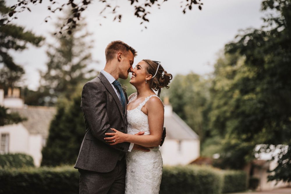 An intimate wedding portrait captured in a lush garden setting at elsick house Aberdeenshire.