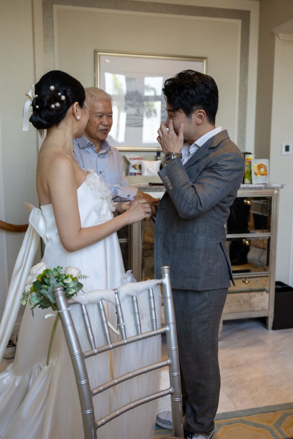 Emotional wedding ceremony moment with couple exchanging rings indoors.