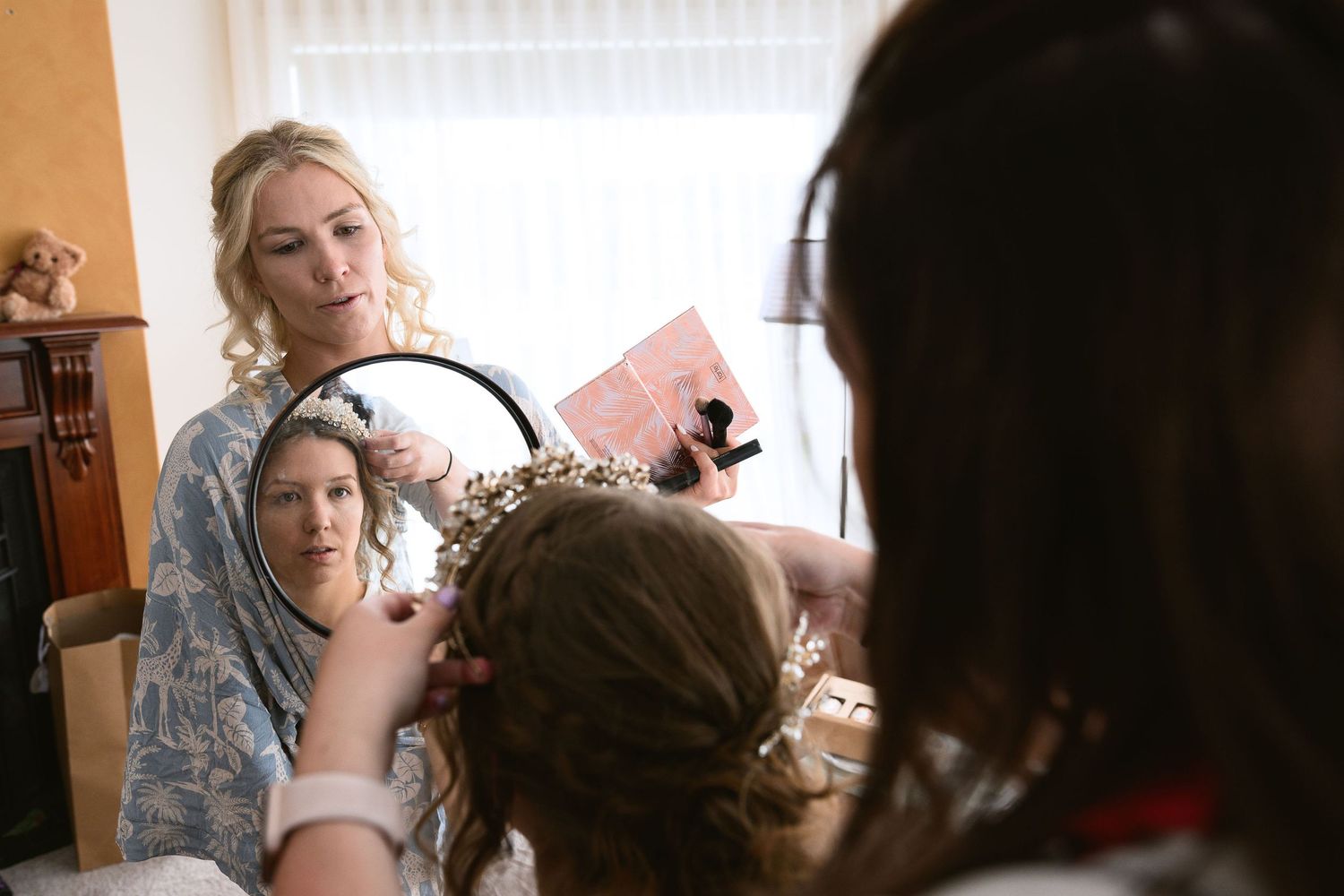 Hairdresser working on client's hairstyle and styling hair in beauty salon interior.