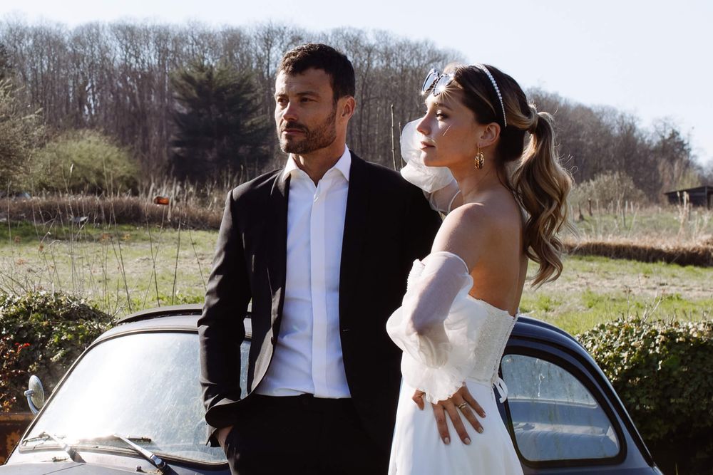 Photo de couple de mariés devant décor de campagne