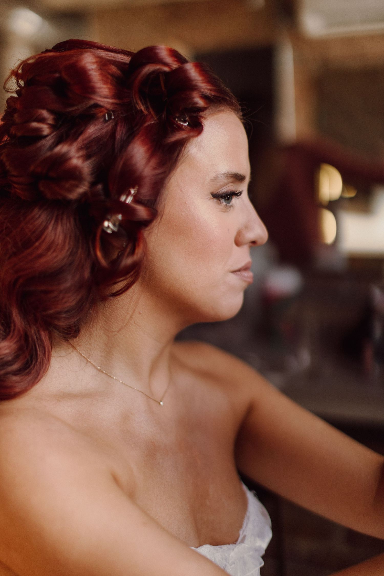 Side profile shots of bride with vintage-inspired red hair and makeup.